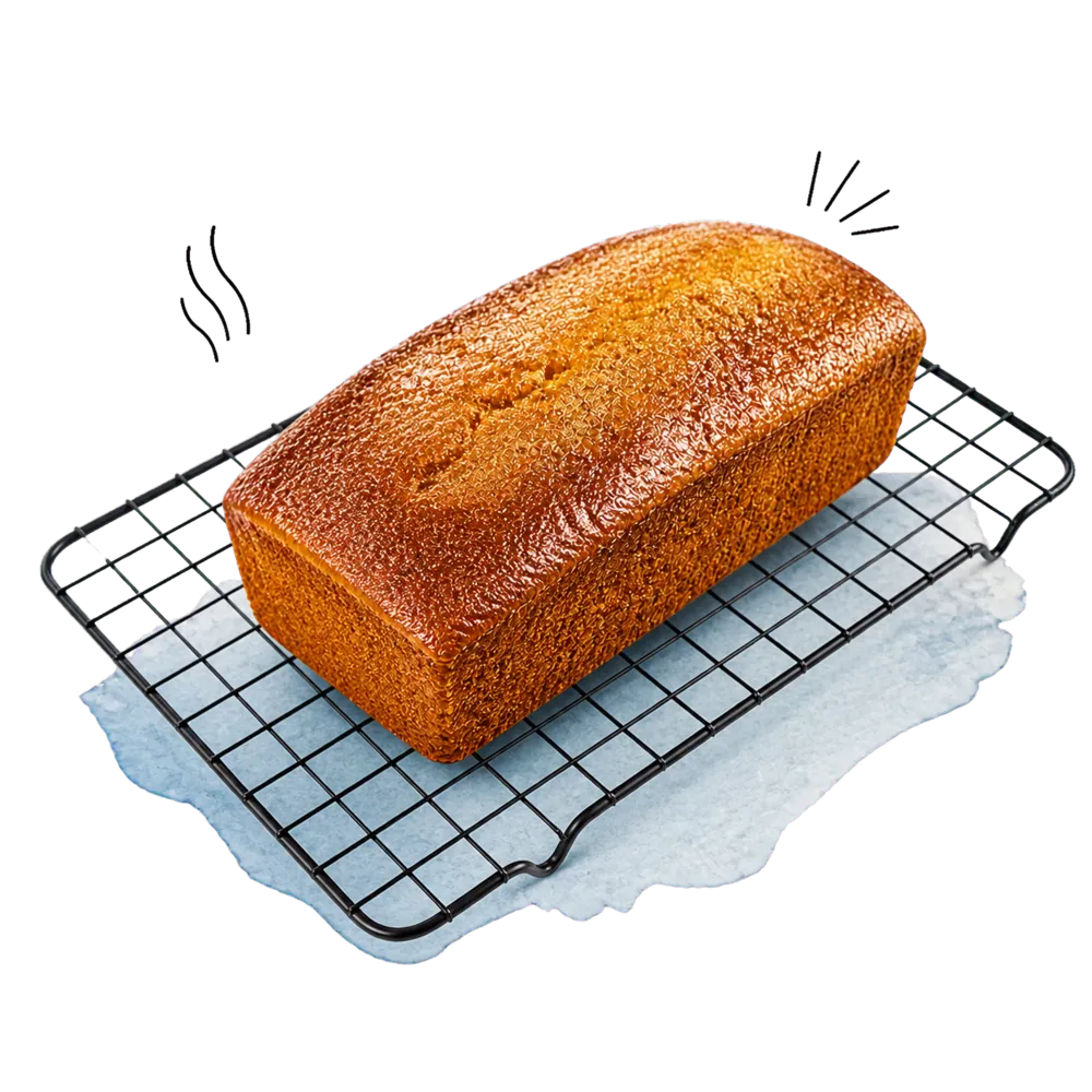 Der ganze glasierte Limetten-Hafer-Kuchen kühlt außerhalb der Form auf einem schwarzen Kuchengitter aus